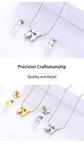 Macro view of gold and silver couple hugging pendant necklaces and earring set