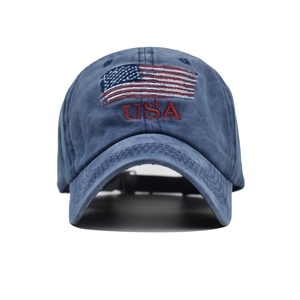 Close-up of vintage washed navy cotton baseball cap featuring embroidered USA flag and text