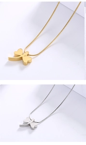 Detail of gold and silver clover pendants with snake chain necklaces for women