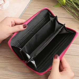 Interior layout of magenta embroidered wallet with card slots and a zipper pocket