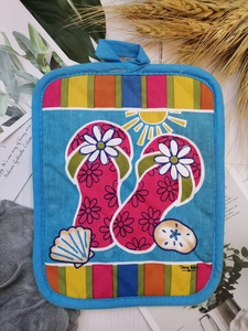 Close-up of sky blue thick cotton oven mat featuring summer beach flip-flop prints