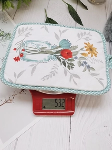 Floral print cotton heat resistant mat with green plaid border showing 53.2g weight