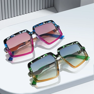 Retro oversized square sunglasses for women with trendy gradient frames on a display stand