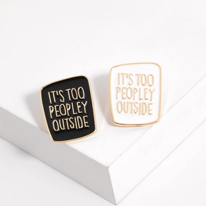 Black and white enamel lapel pins with It's Too Peopley Outside text on white steps