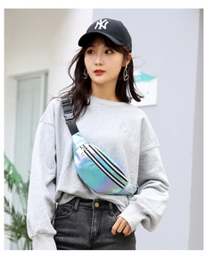 Outdoor model wearing a laser blue holographic waist bag with striped pattern detail