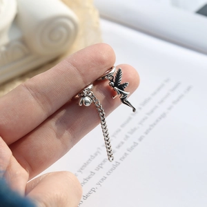 Vintage silver open ring with angel fairy pendant and chain detail on finger