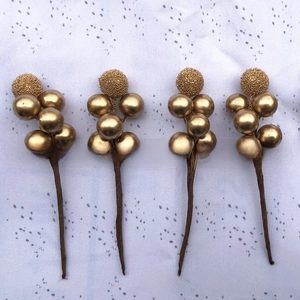 Detail of metallic gold artificial berry stems for wedding candy box decoration