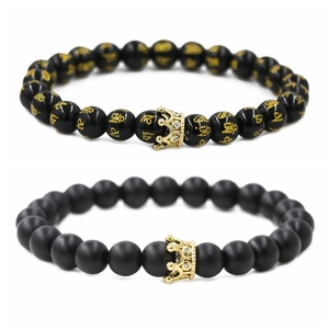 Couples beaded bracelets with matte and polished black stones featuring golden crowns