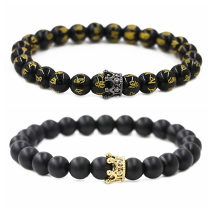 Detail of beaded crown bracelets featuring polished black beads and matte frosted stones
