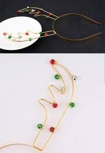 Detail shot of golden metal reindeer antler headband with colorful festive bells