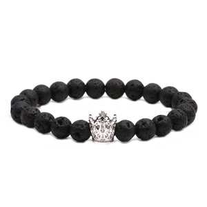 Detail of 8mm black lava stone beads and silver crown charm on a stretch bracelet