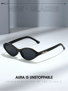 Close-up of retro cat-eye sunglasses with gold accent on black frame and dark lenses