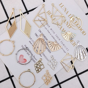 Detailed view of DIY geometric alloy pendants in gold and silver for earring making