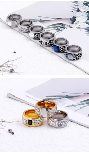 Detailed view of wide metal rings with colorful rhinestones in gold and silver finishes