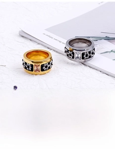 Detailed macro view of wide gold and silver bands featuring rows of pave-set zircons