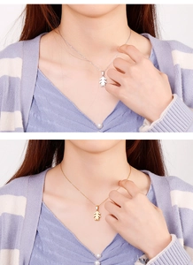 Detailed view of silver and gold girl silhouette pendants on stainless steel necklaces