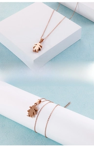 Detail of rose gold girl pendant necklace with delicate chain on blue background