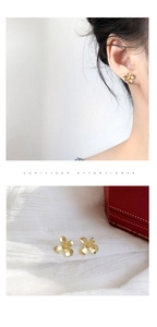 Macro shot of gold gardenia floral stud earrings with premium matte finish texture