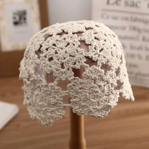 Detailed handmade crochet beige cotton hat with intricate floral hollow-out patterns