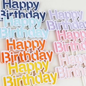 Colorful macaron Happy Birthday cake toppers in blue orange yellow and pink hues