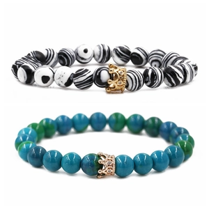 Malachite crown bead bracelets for couples with golden accents and zebra stone texture