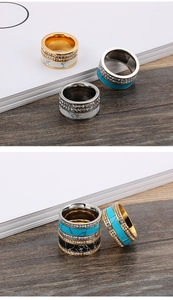 Macro detail of wide stainless steel ring with turquoise inlay and double row of zircons