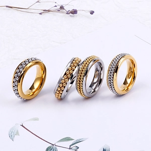 Set of four minimalist stainless steel spinner rings with beaded and braided textures