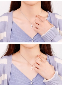 Delicate dolphin pendant necklaces shown in silver and rose gold finish on a model