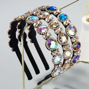 Detail of luxury rhinestone headbands with large gemstones on a gold metal display