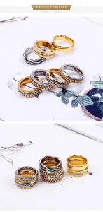 Close-up of stacked stainless steel bead and zircon micro-pave rings in gold and silver