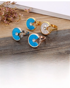 Detail of rose gold and silver rings featuring shell and turquoise geometric discs