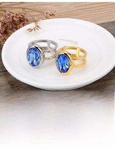 Detailed view of double-layer stainless steel ring with oval blue gemstone inlay