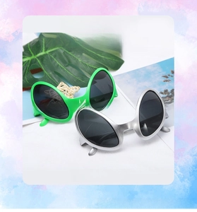 Detail of green and silver alien party glasses for costume festivals and stage props