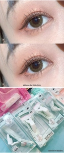 Detail of colorful press-type eyelash curlers in pink, white, and green for long-lasting curls