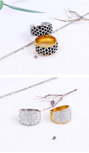 Detailed view of wide fashion rings with rhinestones in gold and silver plating