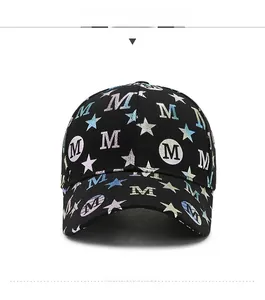 Front view detail of a black cotton baseball cap with star patterns and M letter print