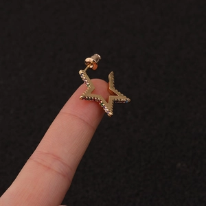 Bohemian gold star stud earring with colorful zircon stones held on a finger