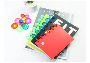 Close-up of 28mm transparent colorful disc-bound rings on mushroom hole notebooks