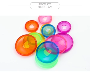Close-up of colorful translucent mushroom hole binding discs with heart cutouts