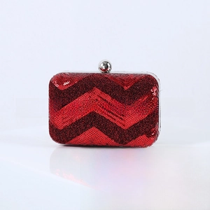 Detailed macro view of the red sequin evening clutch featuring a V-shaped wave pattern