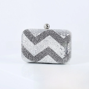 Detailed view of silver and black chevron sequin evening clutch with sphere clasp