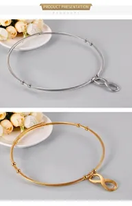 Detail of infinity symbol steel wire bracelets in gold and silver finishes with adjustable beads