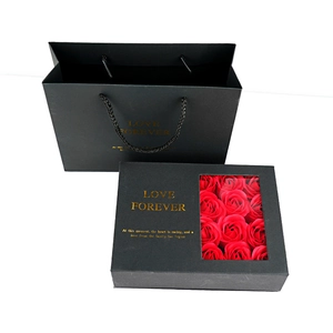 Black flip-top gift box with clear window and red soap roses with matching bag