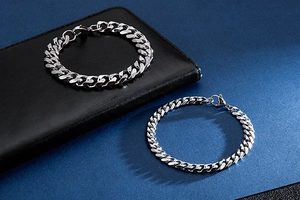 Detail shot of men's stainless steel curb link bracelets in two different thicknesses