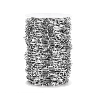 Macro shot of 7mm silver stainless steel oval link chain on white plastic spool