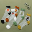 Detailed view of four sheer cotton socks with colorful toe and heel patches and fruit icons