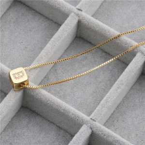 Gold plated square necklace with micro-paved cubic zirconia letter B pendant on velvet