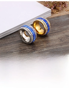 Macro shot of 18k gold and silver plated rings with blue zircon and cubic zirconia