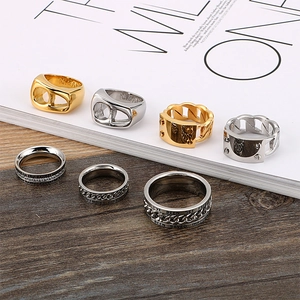 Titanium steel chain rings with cubic zirconia in gold and silver finish on white background