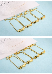 Detail of adjustable gold heart bracelets with alphabet square pendants Q to X